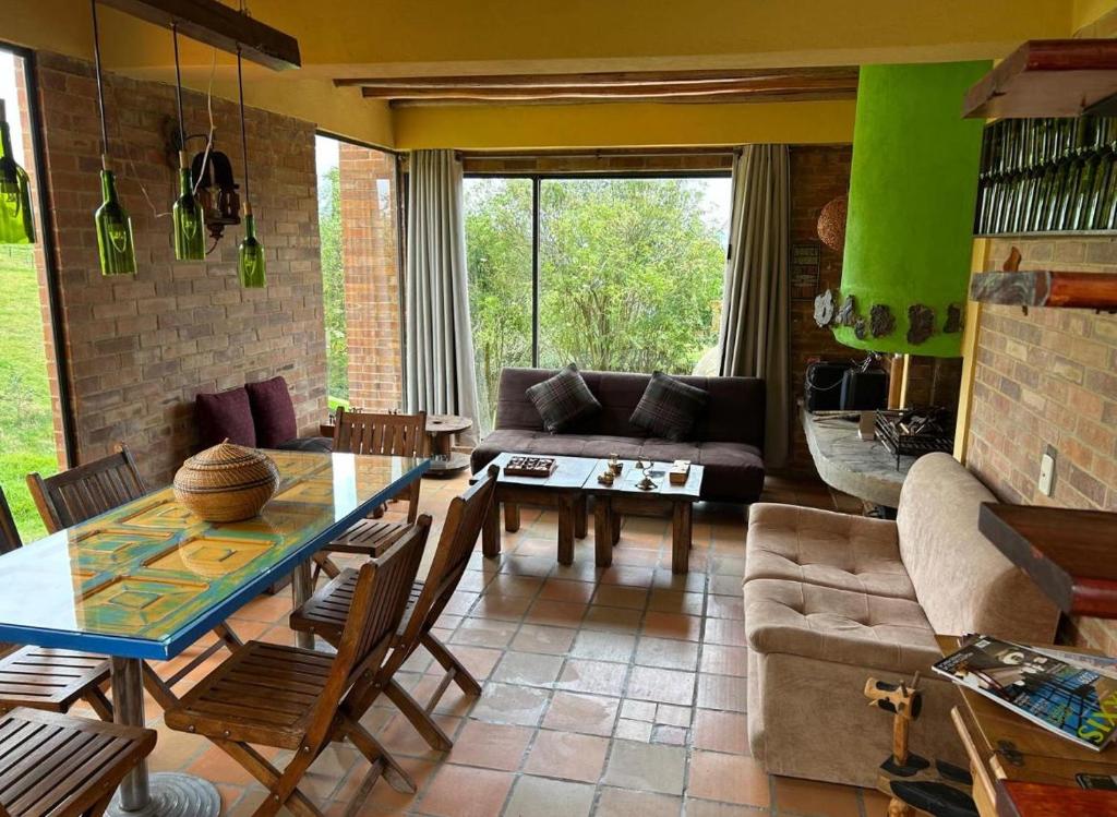 a living room with a table and a couch at Descanso y Naturaleza in Bogotá