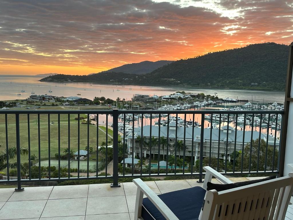 a balcony with a view of the ocean and a harbor at Island Views in Airlie Beach