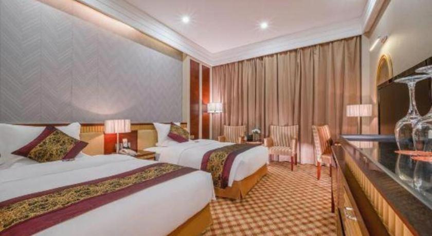 Postel nebo postele na pokoji v ubytování Nanning Yongjiang Hotel