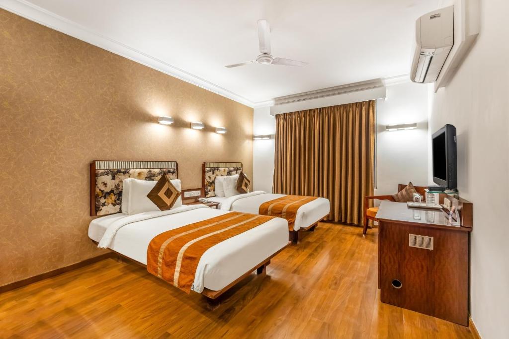Postel nebo postele na pokoji v ubytování Clubhouse Nami Residency Near Sabarmati Riverfront Ahmedabad