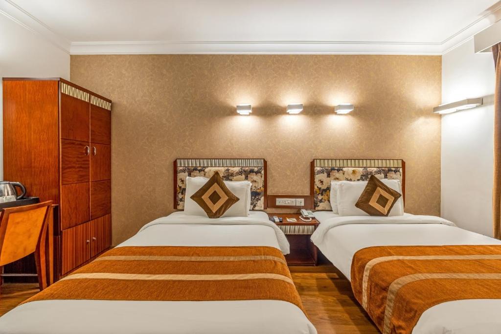 Postel nebo postele na pokoji v ubytování Clubhouse Nami Residency Near Sabarmati Riverfront Ahmedabad