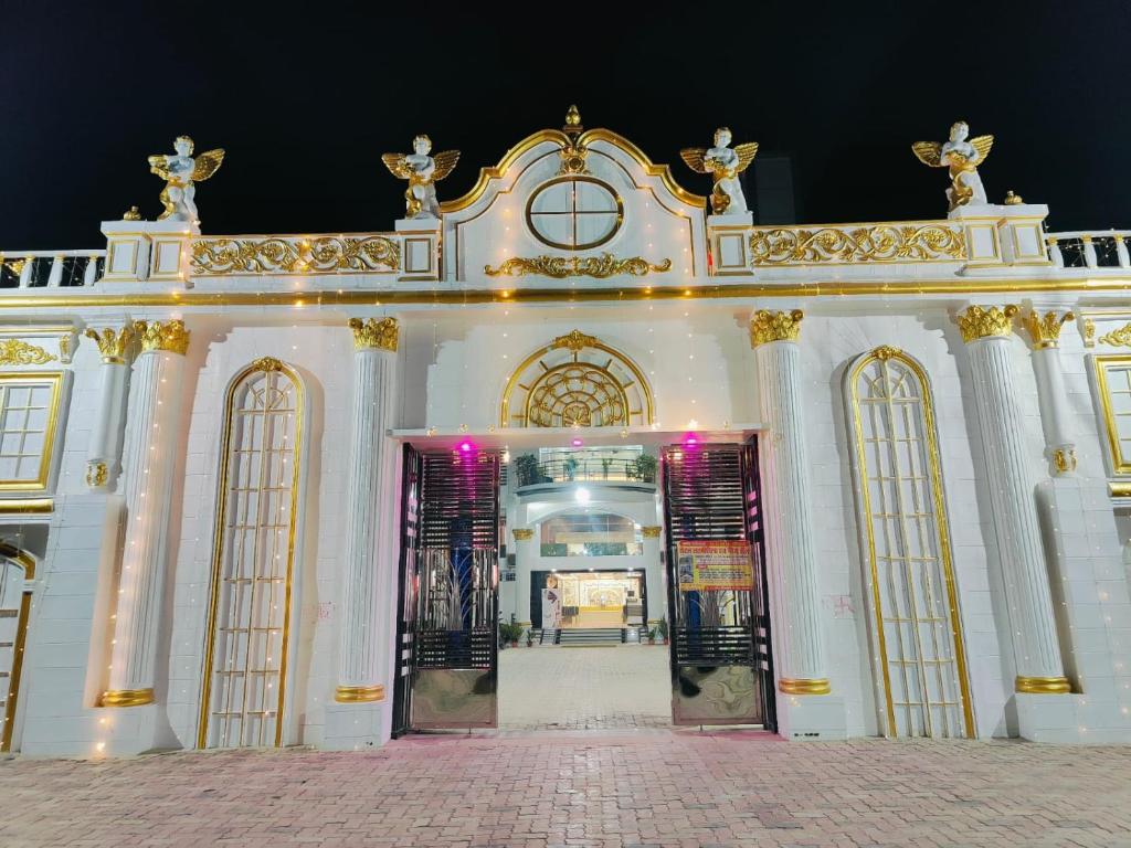 an entrance to a white building with gold accents at Hotel Laxmi villa in Naini