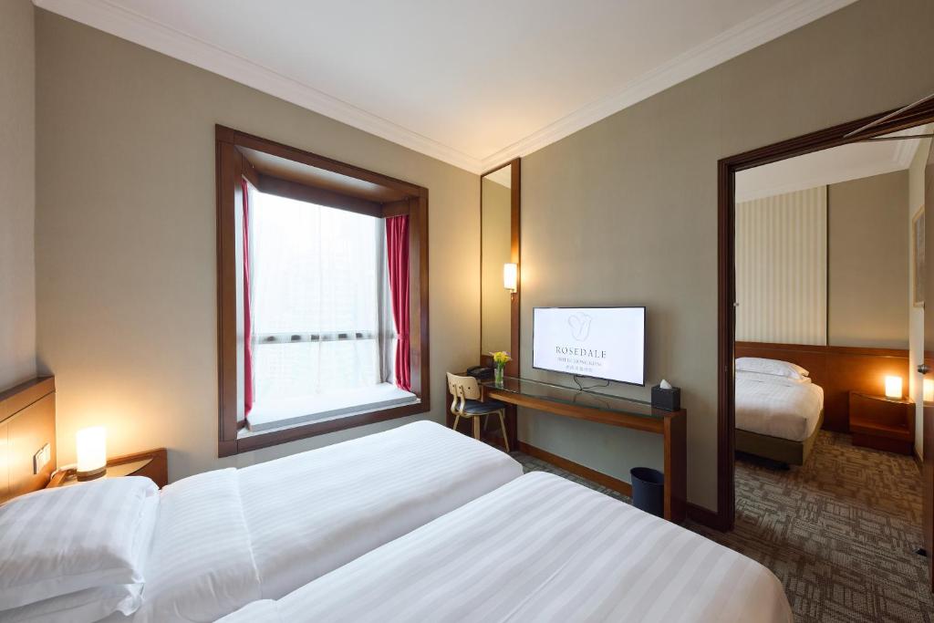 Ein Bett oder Betten in einem Zimmer der Unterkunft Rosedale Hotel Hong Kong