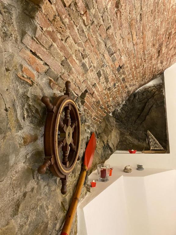 ein Holzschild und ein Messer auf einer Steinmauer in der Unterkunft Rio Alba red loft - holiday house - Riomaggiore 5terre in Riomaggiore