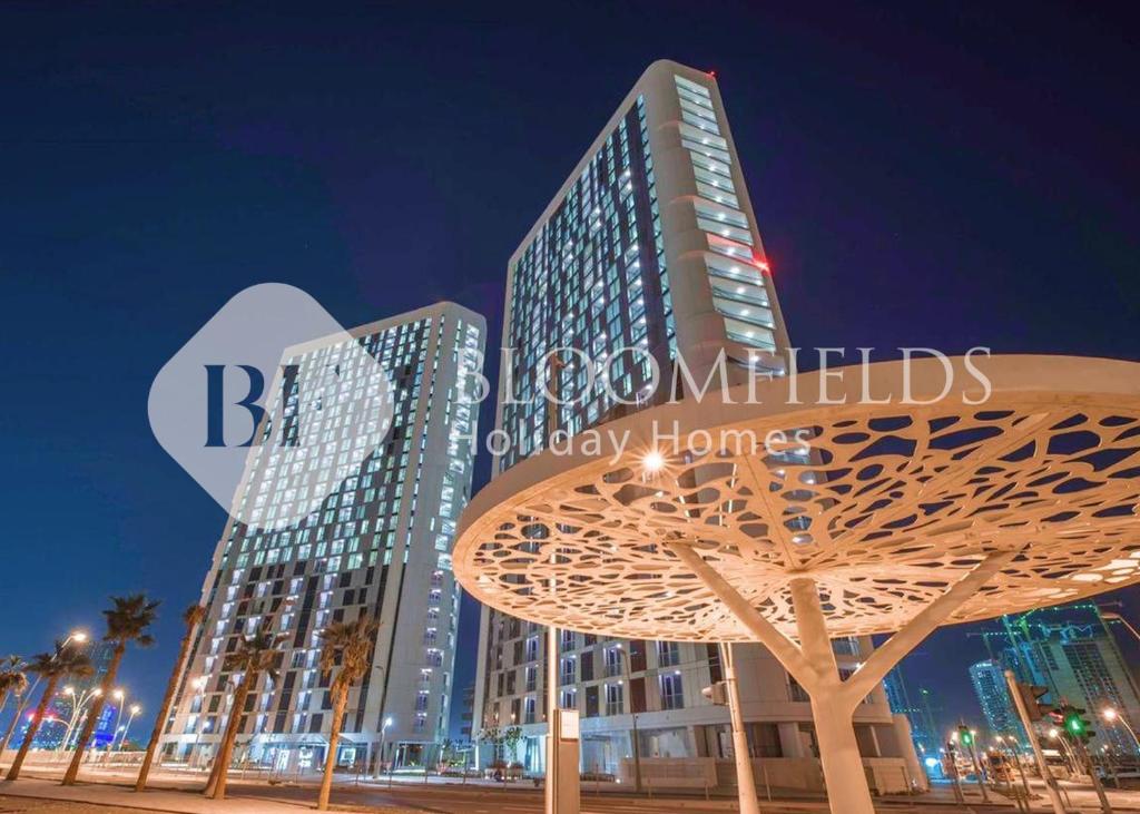 a tall building with a tree in front of it at Bloomfields 1BR Elegant in Shams Meera in Abu Dhabi