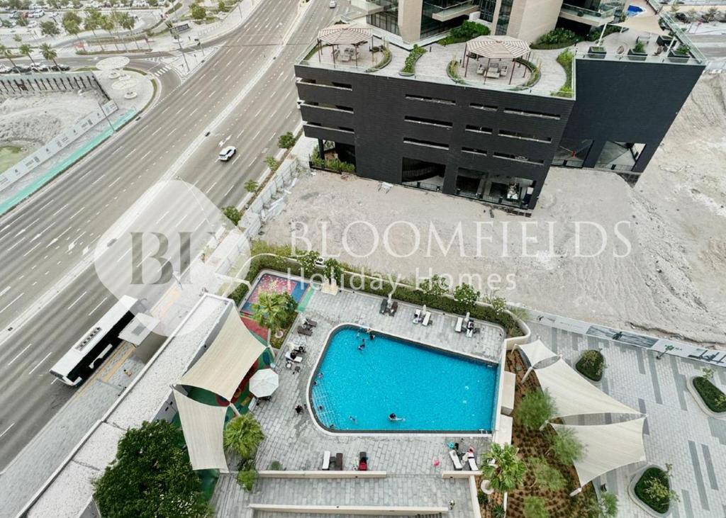 an overhead view of a building with a swimming pool at Bloomfields 1BR Elegant in Shams Meera in Abu Dhabi