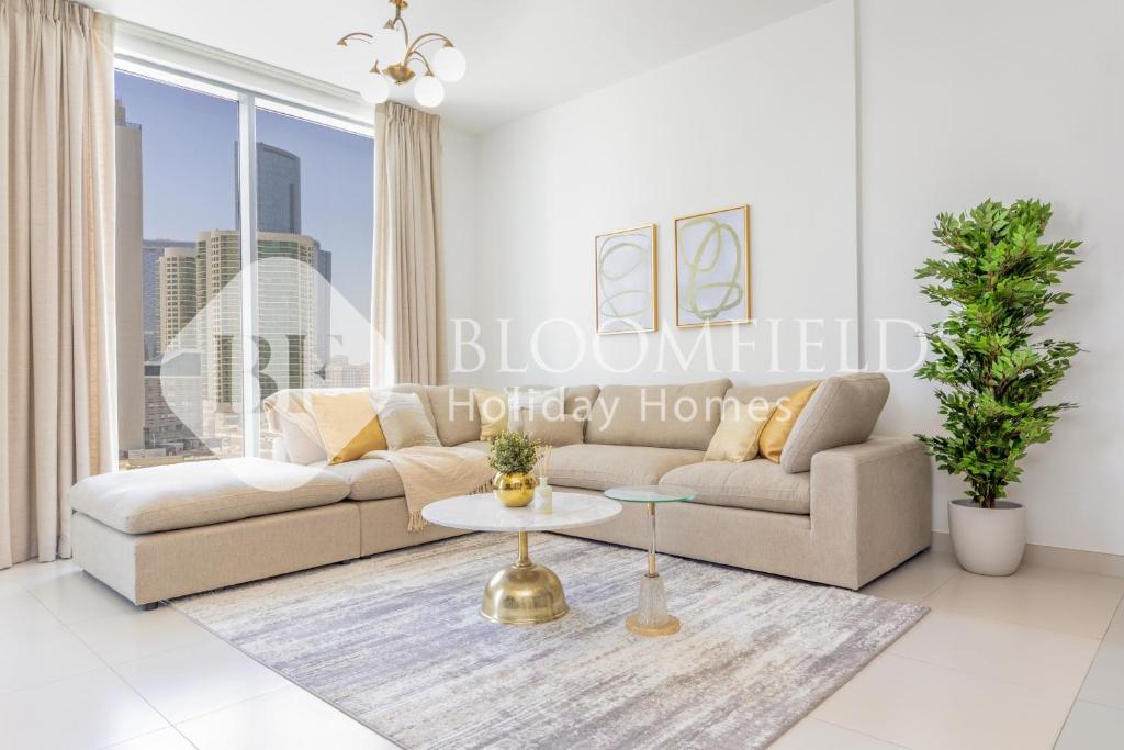 a living room with a couch and a table at Bloomfields 1BR Elegant in Shams Meera in Abu Dhabi