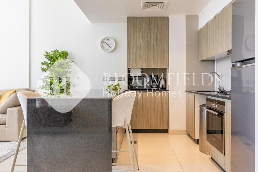 a kitchen with a black counter top in a room at Bloomfields 1BR Elegant in Shams Meera in Abu Dhabi