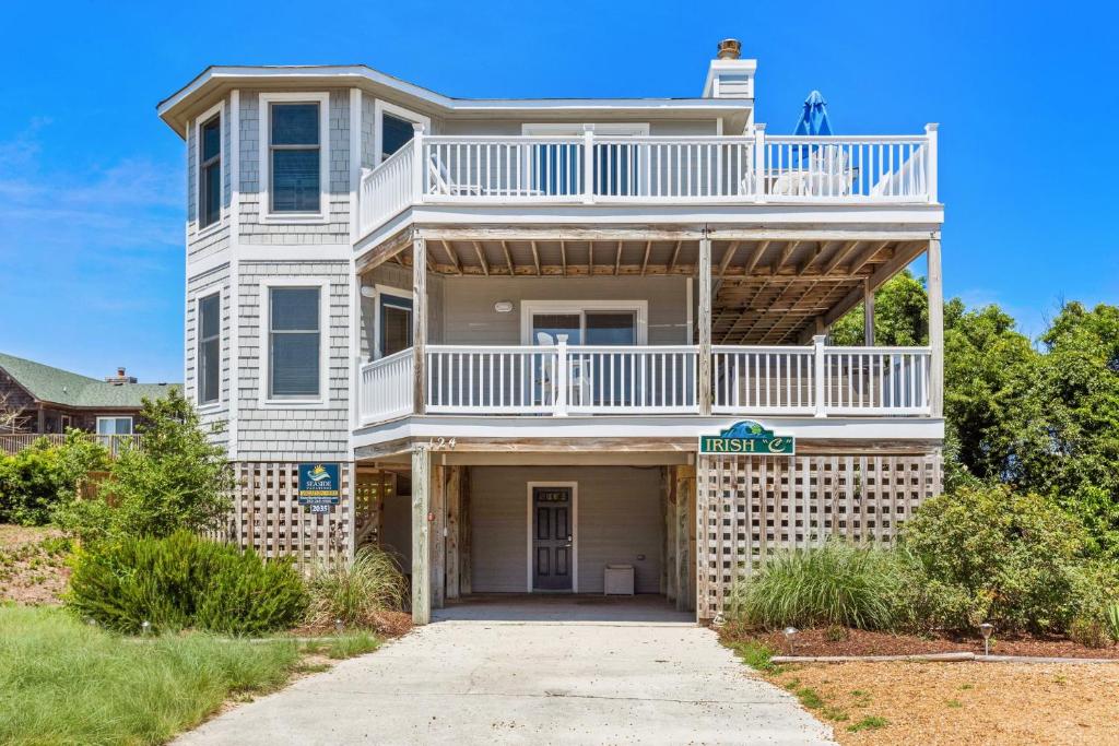a large white house with a balcony on top of it at 2035 - Irish C in Sea Ridge