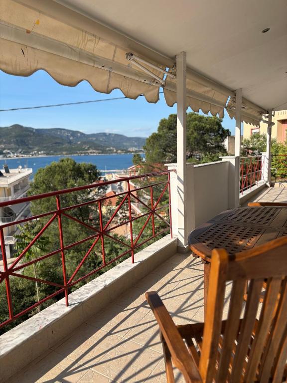 a balcony with a table and a view of the water at Soul Home in Iraklitsa