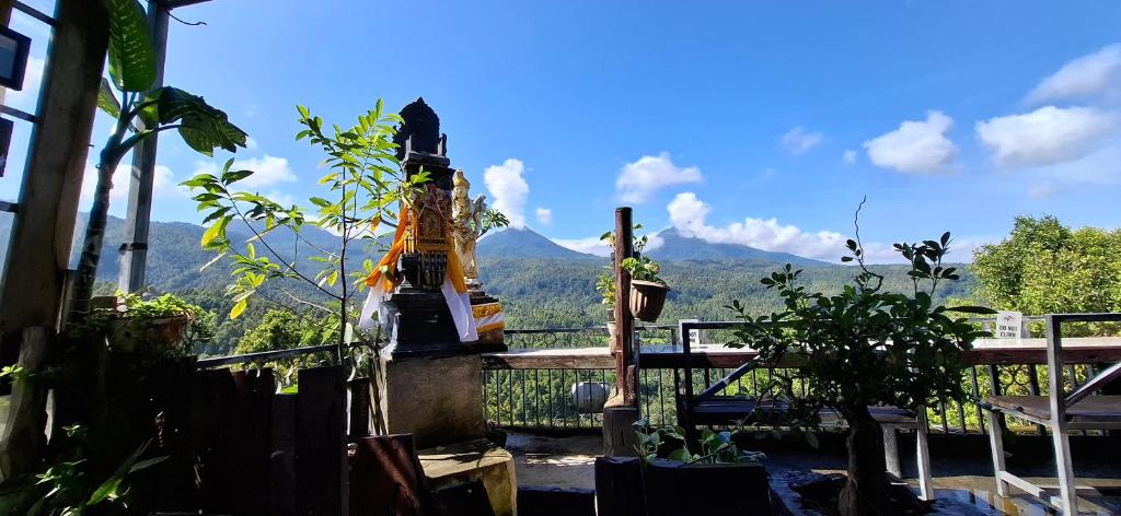 a balcony with a view of a mountain at Umah de Madya The Room & Panoramic Rooftop Munduk in Munduk