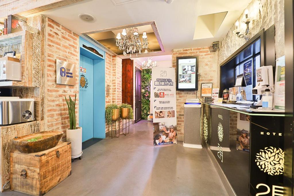 a store with a brick wall and a blue door at Daegu February Hotel Suseong in Daegu