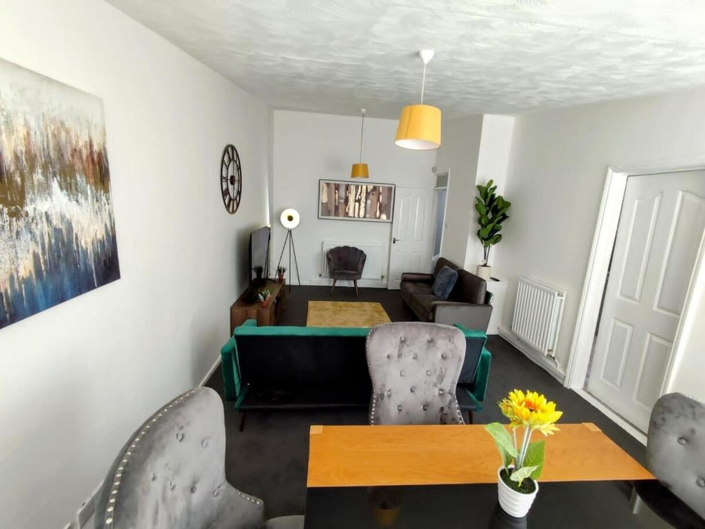 a living room with a table and chairs at Sigma Haven, Free Parking in Old Walker