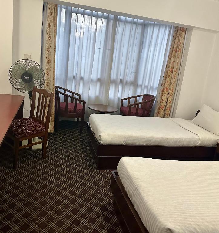 Postel nebo postele na pokoji v ubytování Fuji Hotel