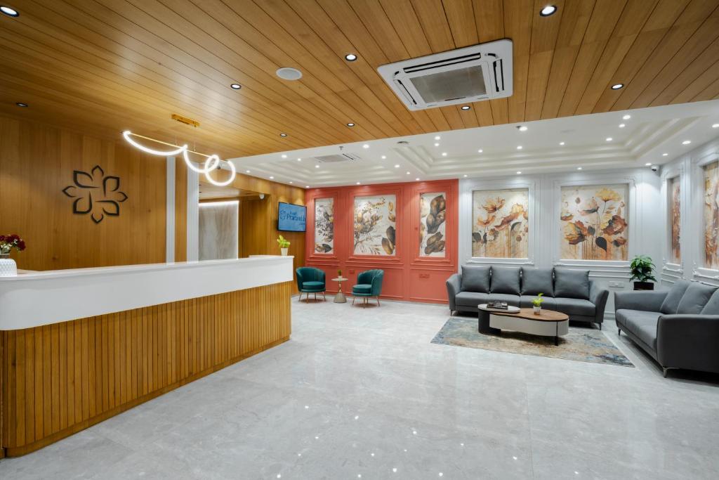 a lobby with a waiting room with couches and chairs at Prarambh By Siara in Nadiād