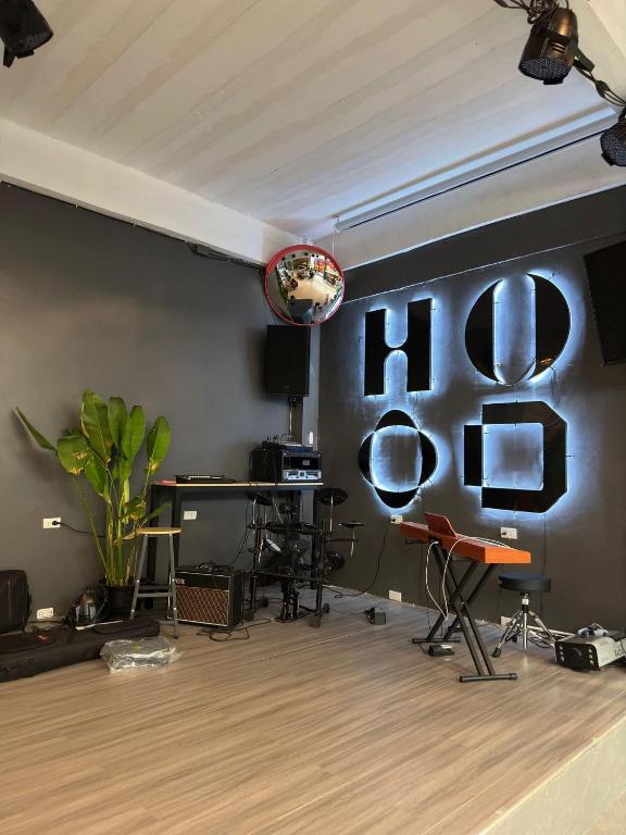 a living room with a table and chairs on a wall at Hood hostel in Jomtien Beach