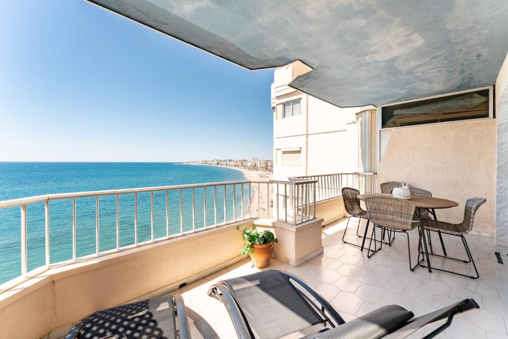 a balcony with a table and chairs and the ocean at Amazing Rey de España Views in Fuengirola