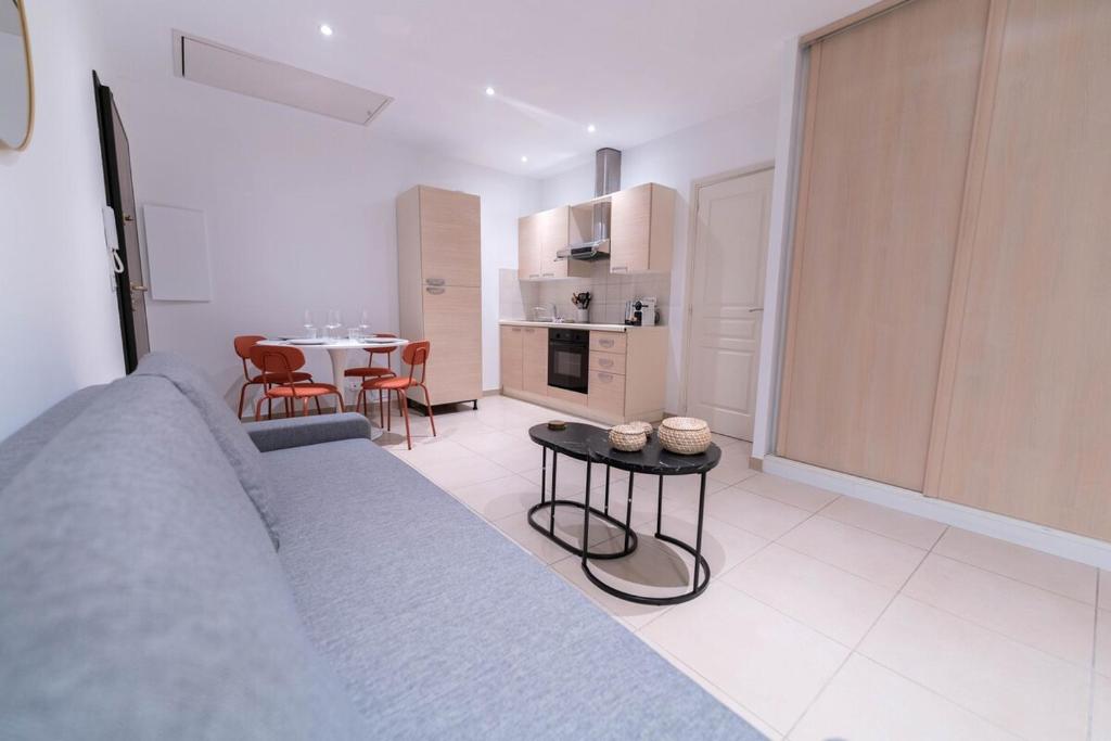 Il comprend un grand salon avec une table et une cuisine. dans l'établissement Cozy apartment - Monaco, à Beausoleil