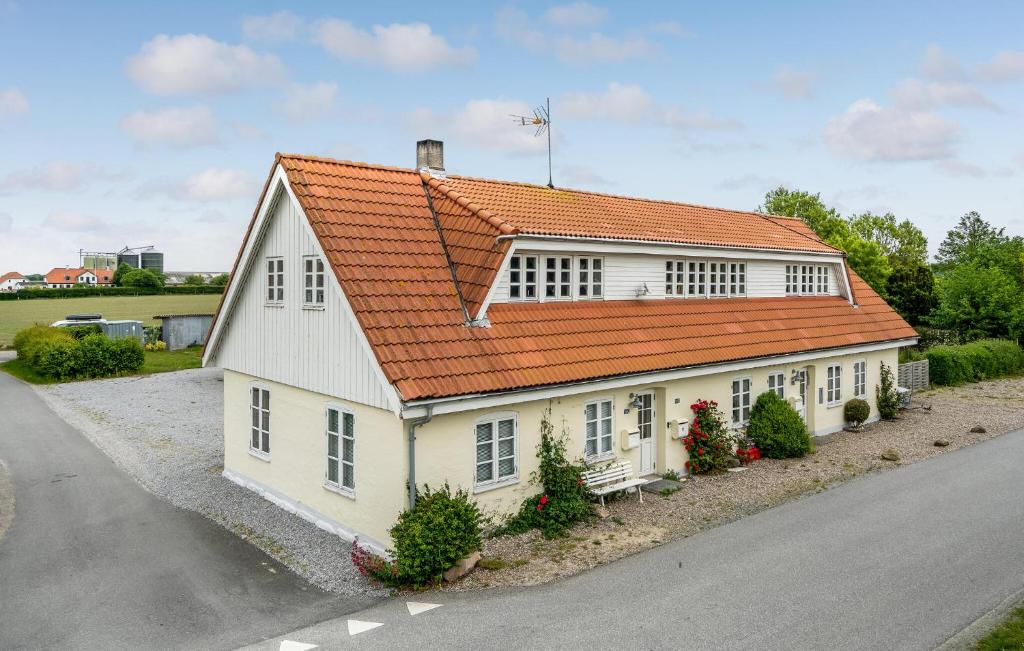 a white house with an orange roof on a street at 3 Bedroom Amazing Home In Sydals in Østerby