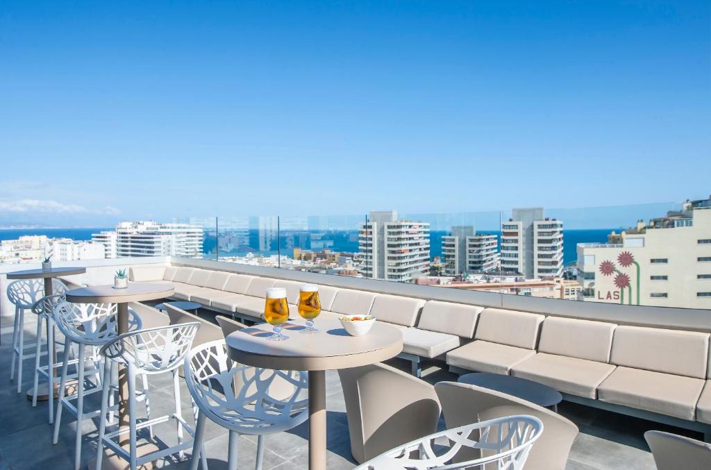 a row of tables and chairs on a balcony at Hotel Costa Málaga - Adults Recommended - by Pierre & Vacances in Torremolinos