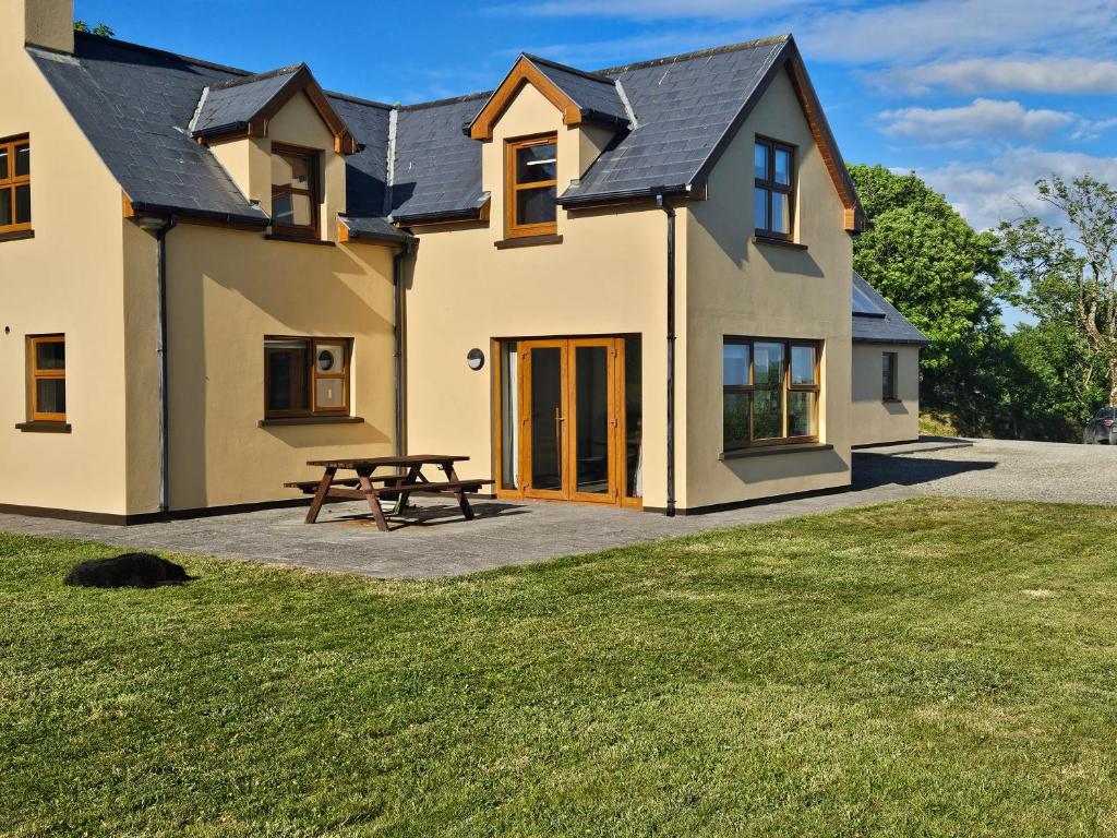 a house with a picnic table in front of it at Beacon View, Church Cross, Skibbereen, County Cork in Church Cross
