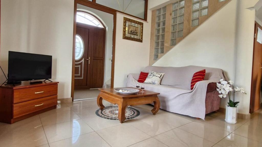 a living room with a couch and a tv and a table at New Villa Dubai - Okrug Gornji,Trogir, Hrvatska in Trogir