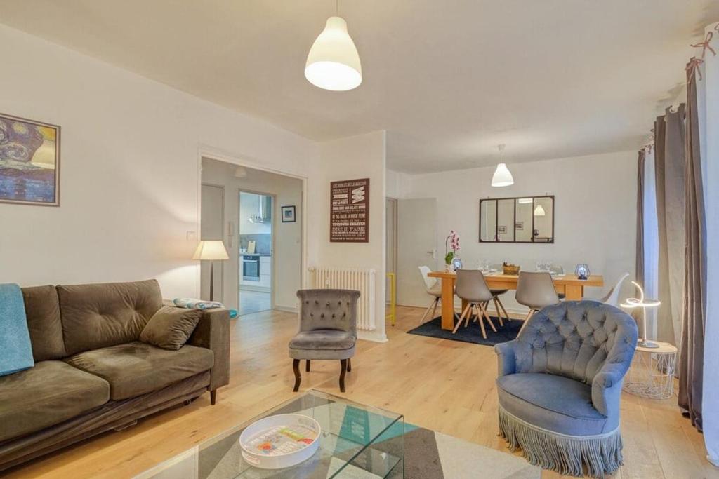 un salon avec un canapé et une table dans l'établissement Le Fougères - 2 chambres, garage privé, à Rennes