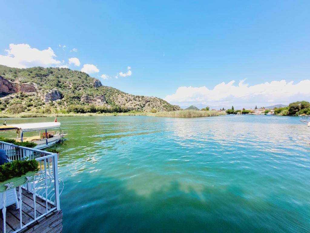 a view of a river with a boat on it at Berg Hotel in Dalyan