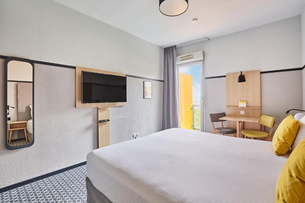 Postel nebo postele na pokoji v ubytování Appart'hôtel Odalys City - Bioparc Lyon Est