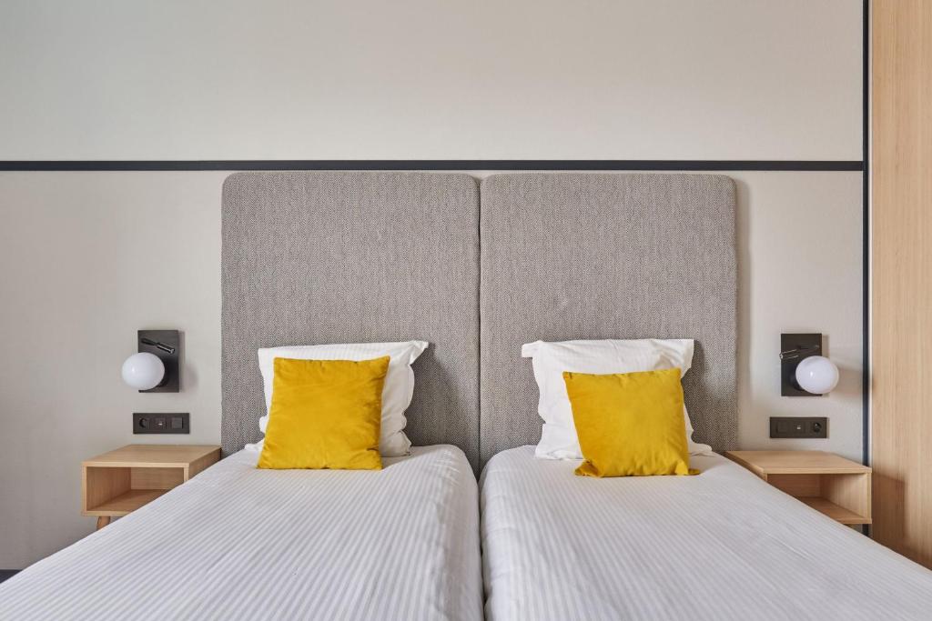Postel nebo postele na pokoji v ubytování Appart'hôtel Odalys City - Bioparc Lyon Est