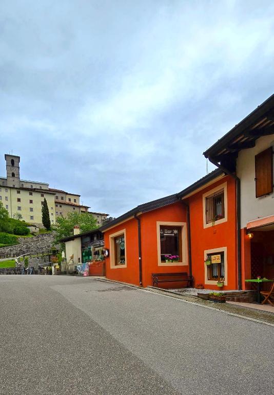 an orange building on the side of a street at Casa Vacanze La Stele in Castelmonte
