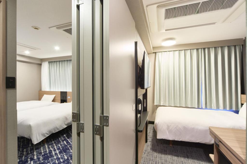 Postel nebo postele na pokoji v ubytování Washington R&B Hotel Shin Yokohama Ekimae