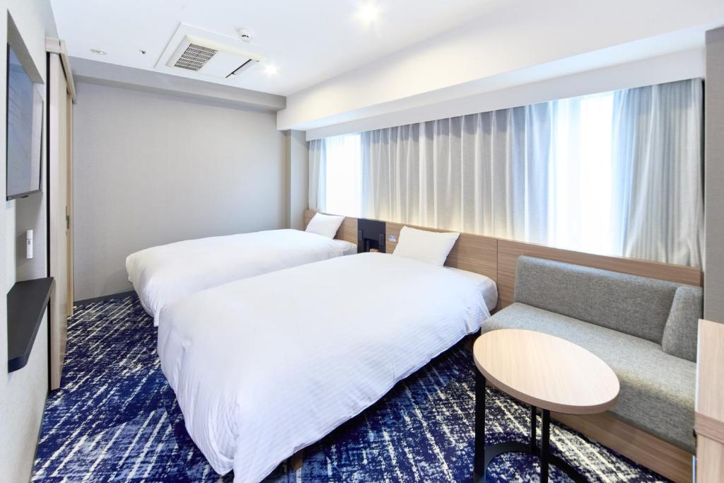 Postel nebo postele na pokoji v ubytování Washington R&B Hotel Shin Yokohama Ekimae