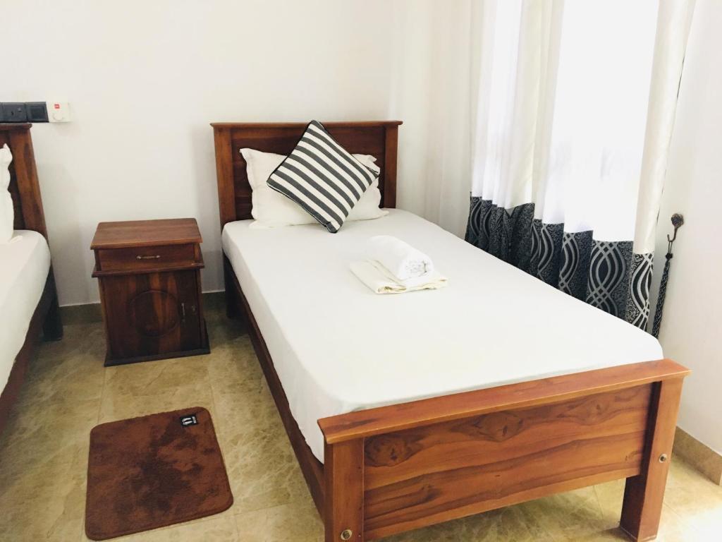 Postel nebo postele na pokoji v ubytování Dimuthu Green Villa