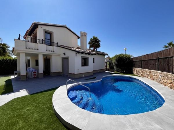 a house with a swimming pool in front of a house at HL 014 Holiday Rental 3 bedroom villa on HDA Golf Resort in Fuente Alamo