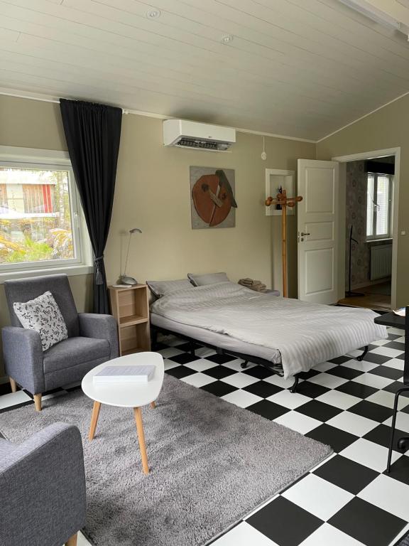 a bedroom with a bed and a checkered floor at Henar Bed & Breakfast in Gävle