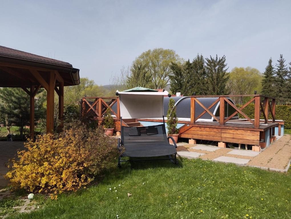 a gazebo and a bench and a boat at Apartmán Greenhouse in Budikovany