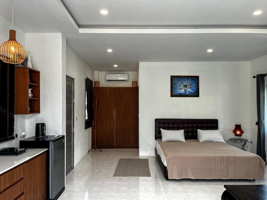 パンガン島にあるBaan Sam3 studio in Thong Salaのベッドルーム1室(ベッド1台付)、キッチンが備わるアパートメントです。