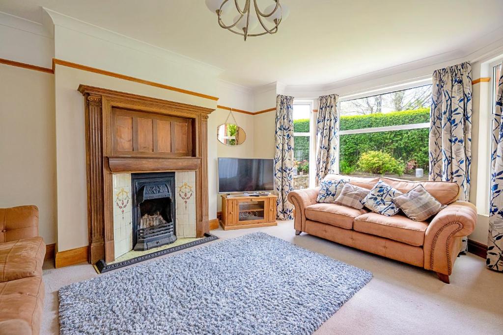 a living room with a couch and a fireplace at Finest Retreats - Sea Bank in Colwyn Bay