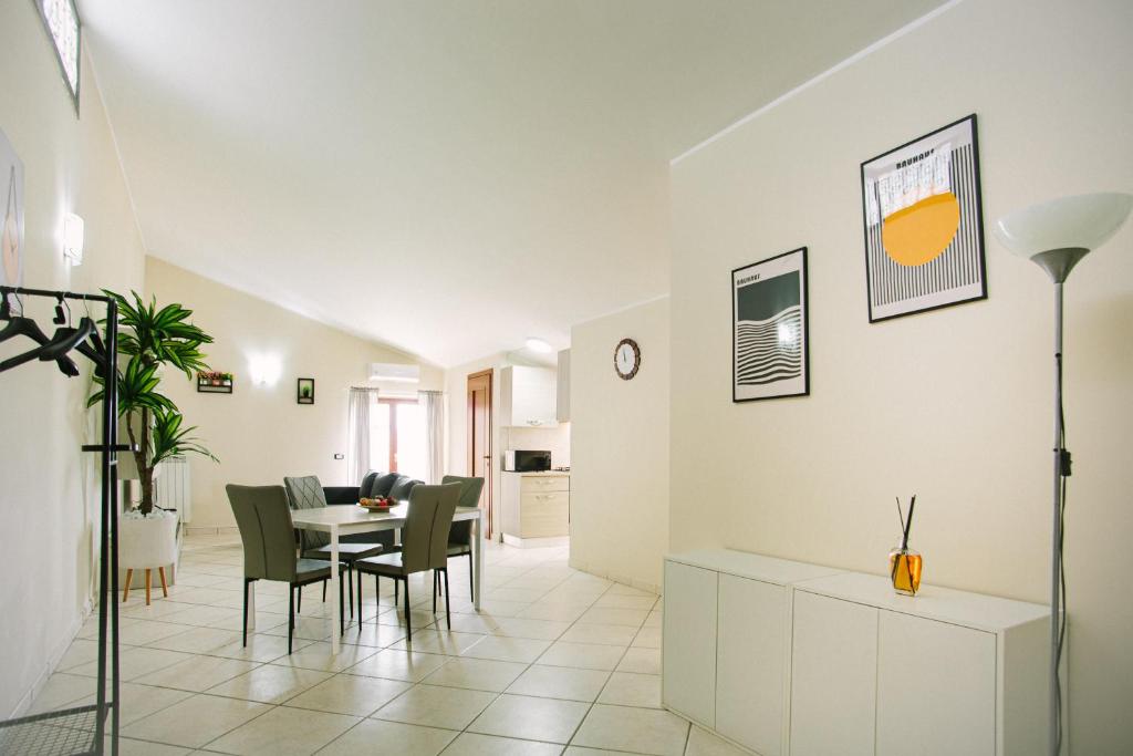 a dining room and living room with a table and chairs at Your Penthouse in San Prisco