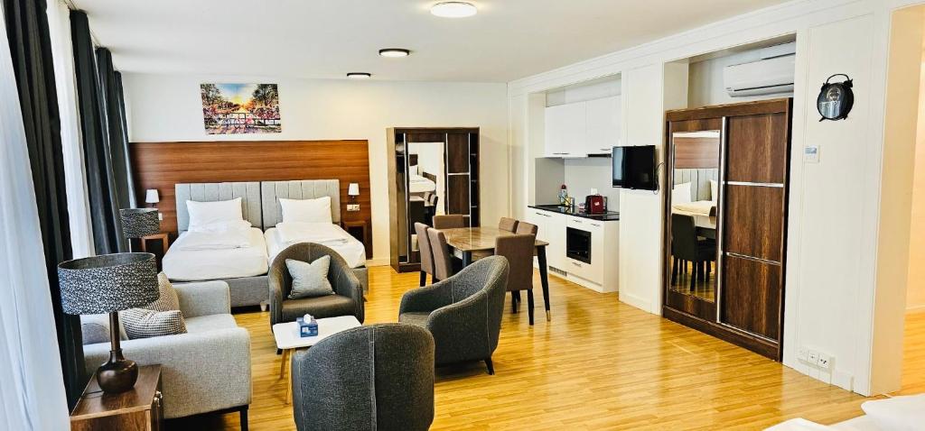 a hotel room with a bed and a living room at Akomo Bern in Bern