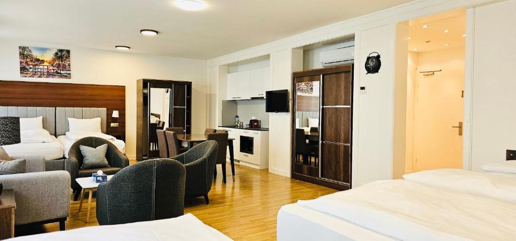 a hotel room with a bed and a living room at Akomo Bern in Bern