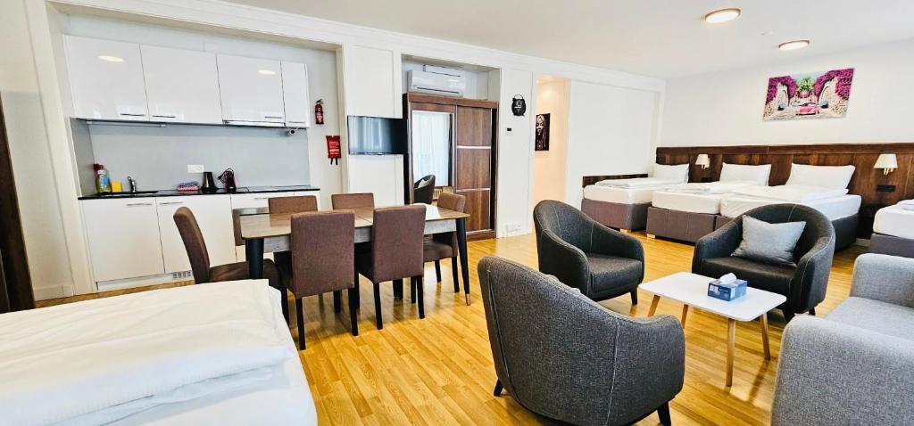 a hotel room with a dining room and a bedroom at Akomo Bern in Bern