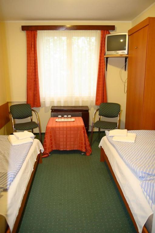 Postel nebo postele na pokoji v ubytování Hotel Touring