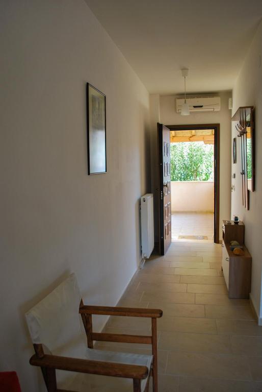 a room with a hallway with a refrigerator and a door at Canal Luxury Apartments in Nea Potidaea