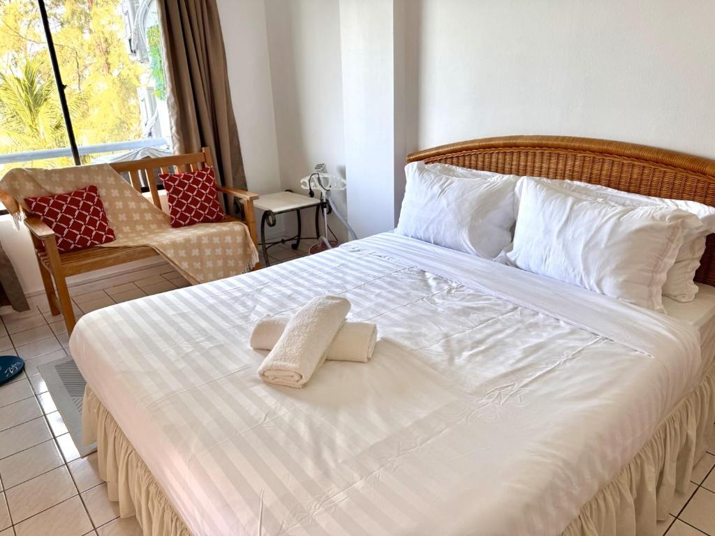 a bedroom with a bed with two towels on it at Corus Seaview Family Suite at Port Dickson 6-8 pax in Port Dickson