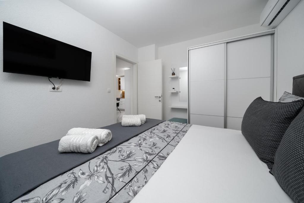 Postel nebo postele na pokoji v ubytování Apartmani Marivo