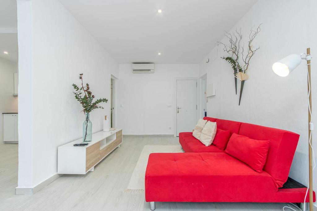 a red couch in a white living room at Milenial Immo VT2-1 Figueres Dali Museum and Rambla in Figueres