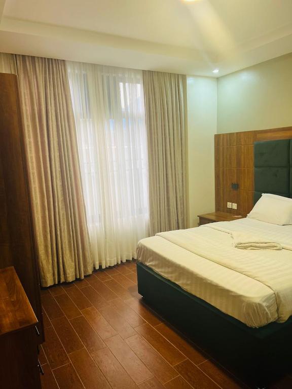 Postel nebo postele na pokoji v ubytování Jikoni Hotel