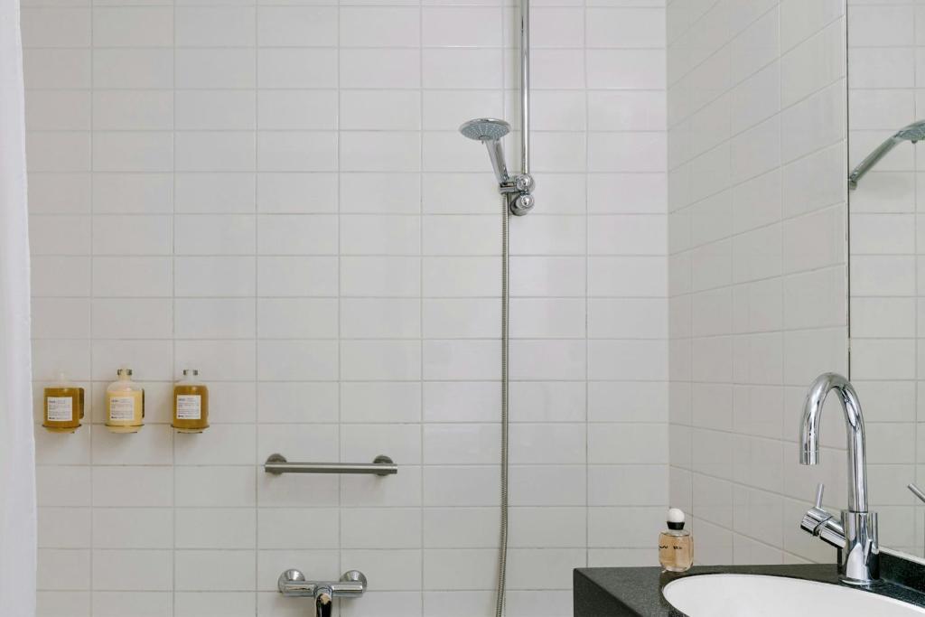 a bathroom with a shower and a sink at Park House Hotel Museum Quarter, Sonder by Marriott Bonvoy in Amsterdam